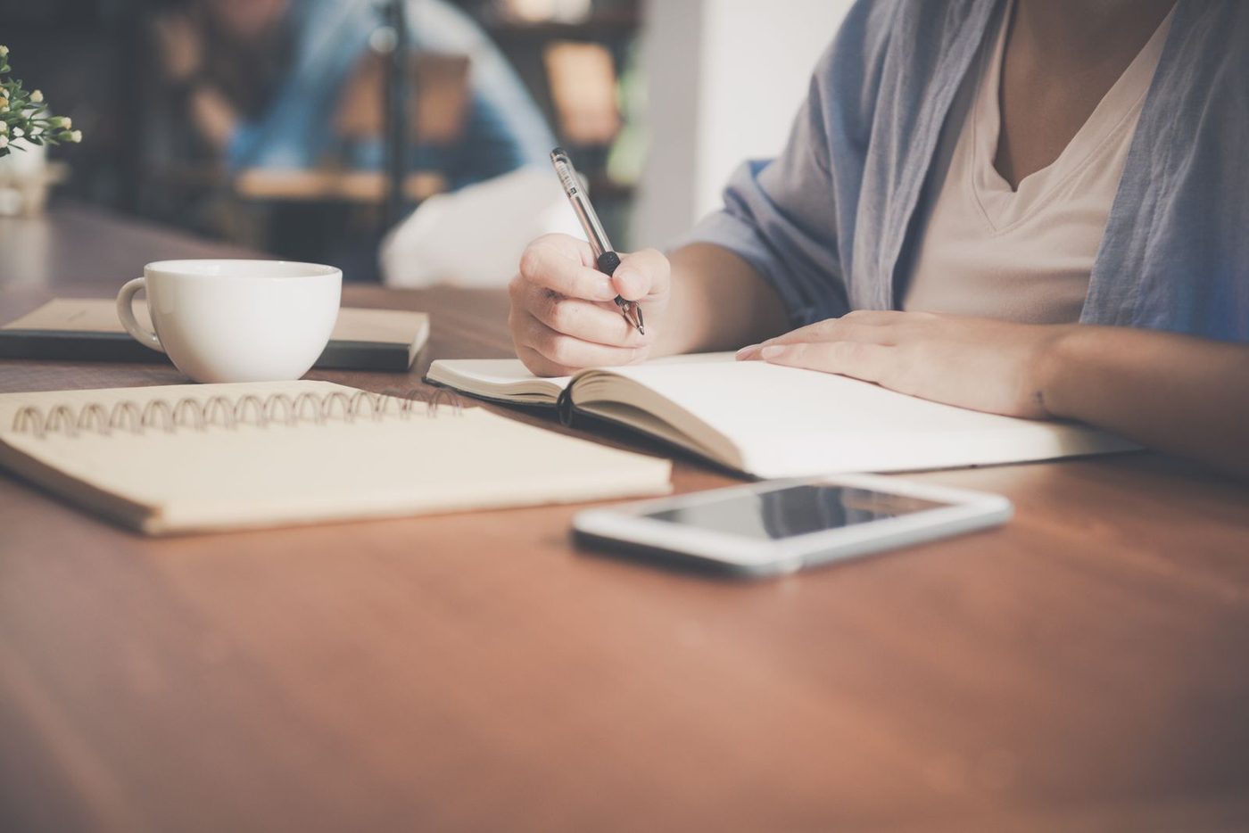 An open notebook with a pen resting on the page