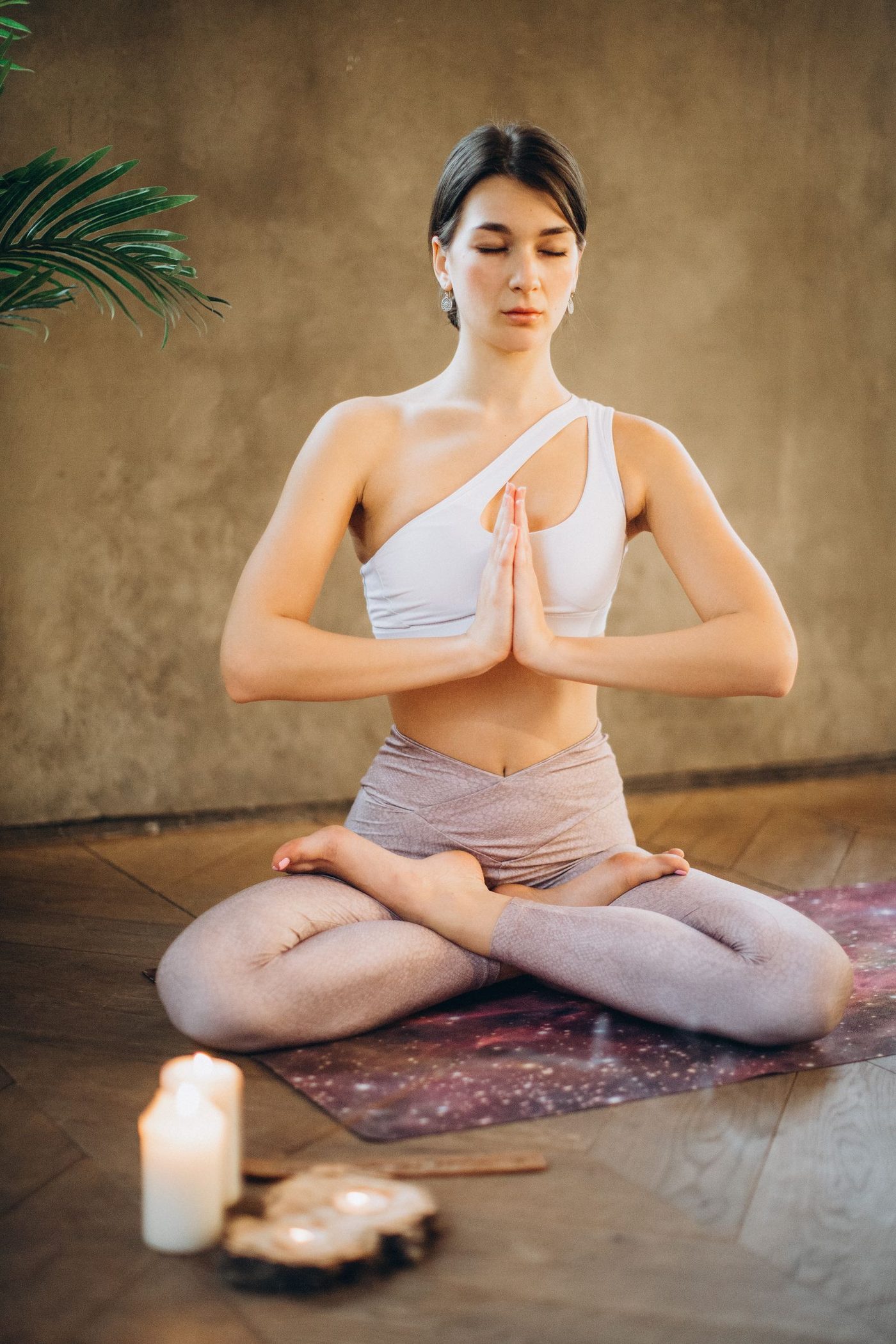 A person stretching both arms overhead outdoors in warm morning light